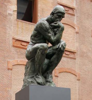The Thinker, a sculpture by Auguste Rodin, shows a nude male figure of over life-size sitting on a rock with his chin resting on one hand as though deep in thought. This picture is from this museum's website, Musee Rodin.